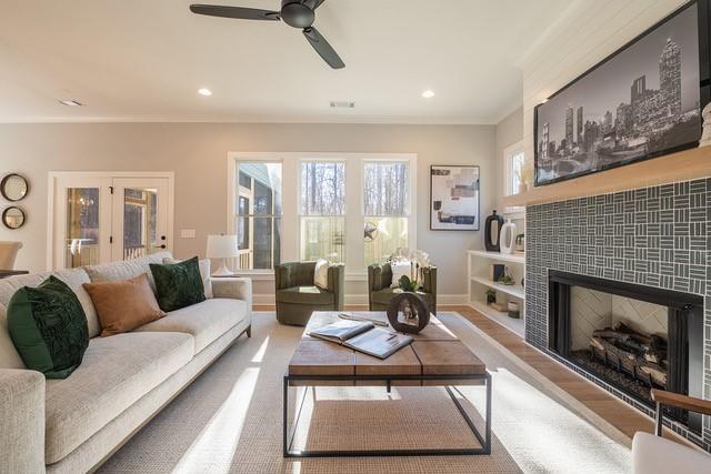 living area with ornamental molding, a tile fireplace, baseboards, and recessed lighting