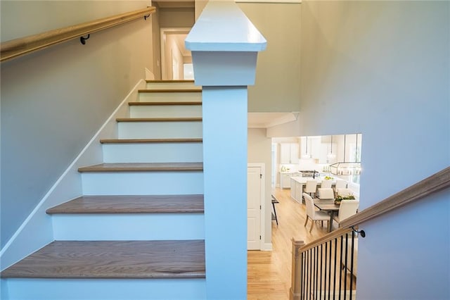 stairs featuring wood finished floors