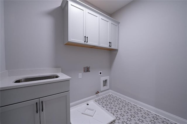 laundry area featuring cabinet space, baseboards, gas dryer hookup, washer hookup, and electric dryer hookup