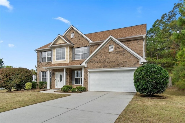 view of front of home featuring a front yard and a garage