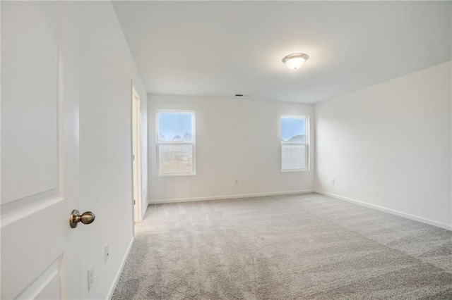 unfurnished room with light colored carpet