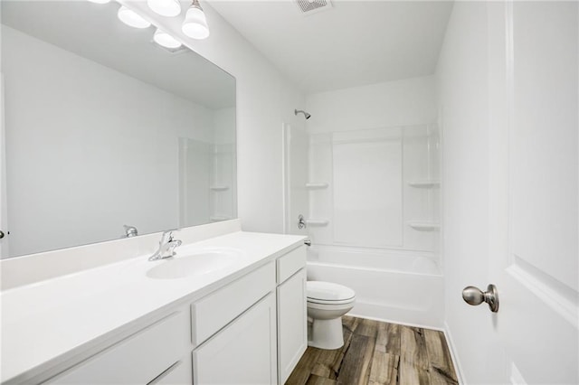 full bathroom featuring vanity, wood-type flooring, shower / tub combination, and toilet