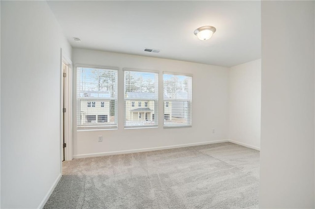 spare room featuring light colored carpet