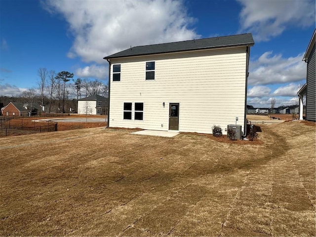 back of property featuring central AC, a yard, and a patio