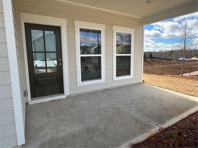 property entrance featuring a patio