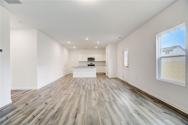 unfurnished living room with light wood-type flooring