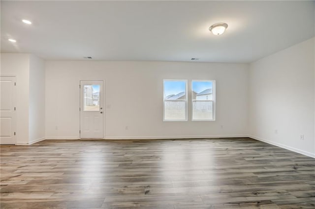 unfurnished room featuring wood-type flooring