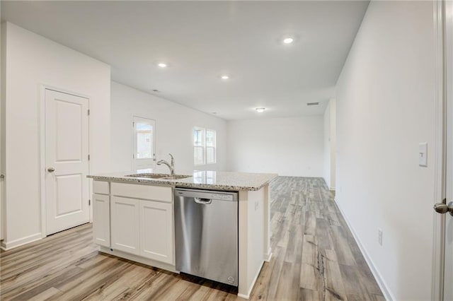 kitchen featuring sink, light stone counters, stainless steel dishwasher, an island with sink, and white cabinets