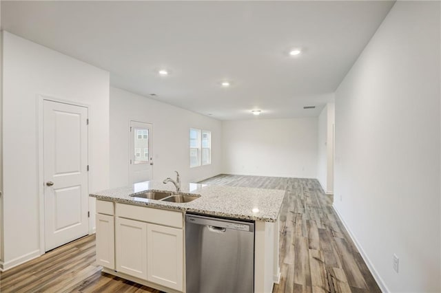 kitchen featuring sink, dishwasher, a kitchen island with sink, white cabinetry, and light stone countertops