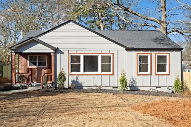 bungalow-style home featuring roof with shingles, crawl space, and board and batten siding