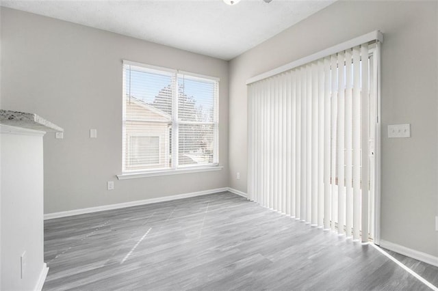 interior space with baseboards and wood finished floors