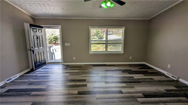 entrance foyer with a textured ceiling, dark wood-type flooring, visible vents, baseboards, and ornamental molding