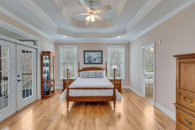 bedroom featuring a raised ceiling, crown molding, access to exterior, and light wood-style flooring