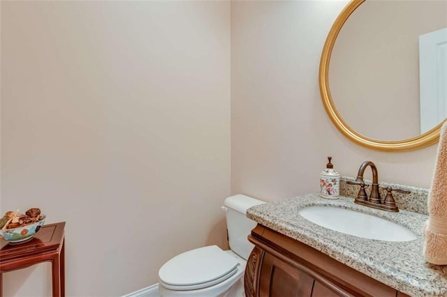 half bathroom featuring toilet and vanity