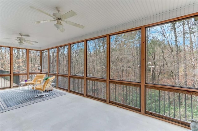 unfurnished sunroom featuring ceiling fan