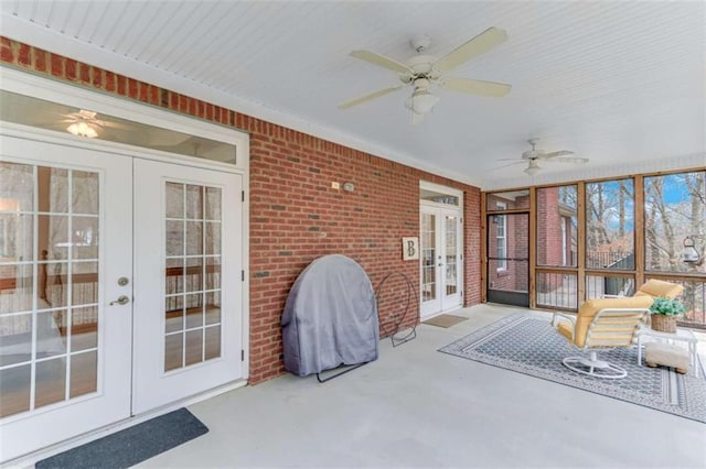 sunroom / solarium featuring french doors and ceiling fan