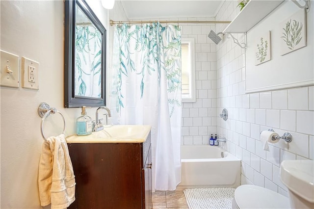 bathroom with toilet, vanity, tile walls, and shower / bathtub combination with curtain