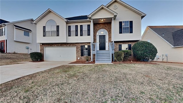 split foyer home featuring a garage and a front yard