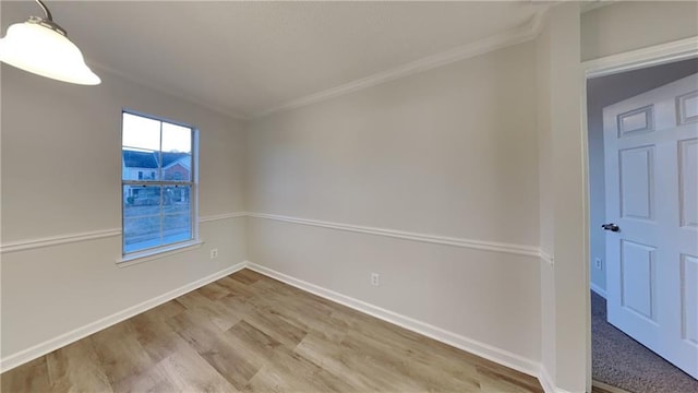 unfurnished room with crown molding and light wood-type flooring