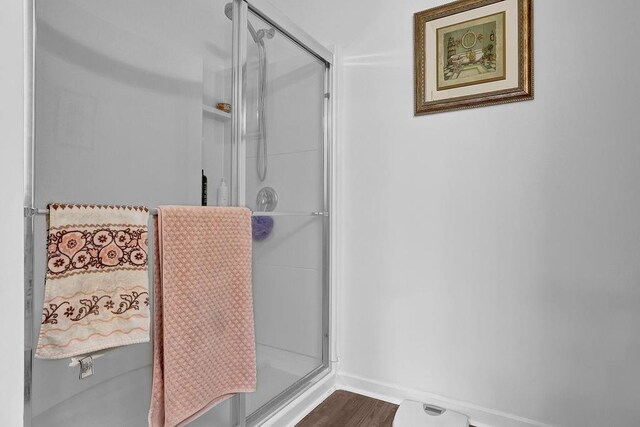 bathroom featuring a shower with shower door