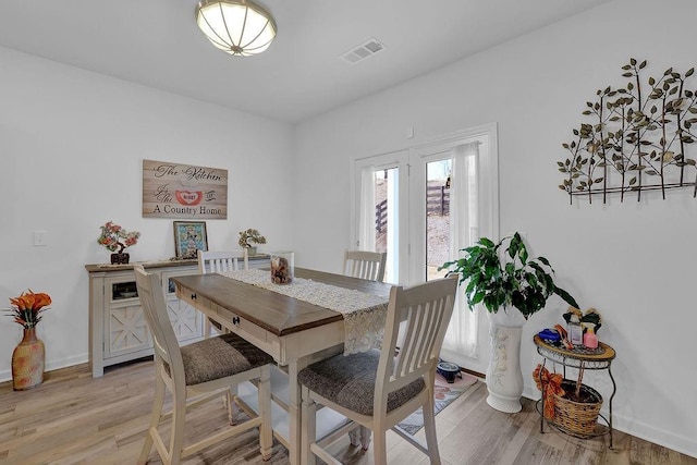 dining space with light hardwood / wood-style flooring