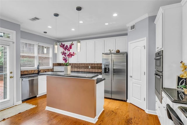 947 Summer Forest Dr, Suwanee, GA 30024 - kitchen with appliances with stainless steel finishes, decorative backsplash, white cabinets, plenty of natural light, and ornamental molding