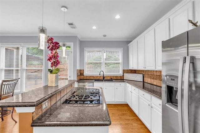 947 Summer Forest Dr, Suwanee, GA 30024 - kitchen featuring stainless steel fridge, a sink, a center island, ornamental molding, and dark stone countertops
