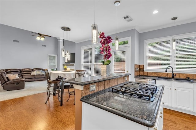947 Summer Forest Dr, Suwanee, GA 30024 - kitchen featuring a sink, black gas stovetop, a kitchen island, light wood finished floors, and white cabinetry