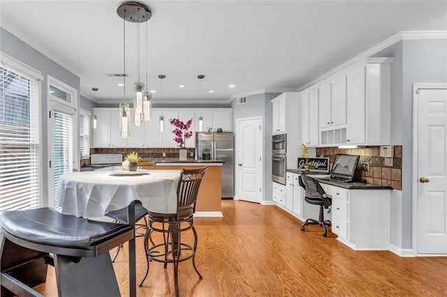 947 Summer Forest Dr, Suwanee, GA 30024 - kitchen featuring appliances with stainless steel finishes, dark countertops, light wood-type flooring, tasteful backsplash, and ornamental molding