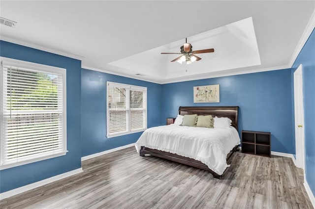 947 Summer Forest Dr, Suwanee, GA 30024 - bedroom with a tray ceiling, baseboards, wood finished floors, ornamental molding, and a ceiling fan