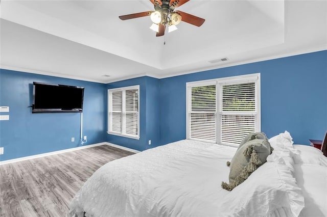 947 Summer Forest Dr, Suwanee, GA 30024 - bedroom featuring a raised ceiling, wood finished floors, baseboards, ceiling fan, and ornamental molding