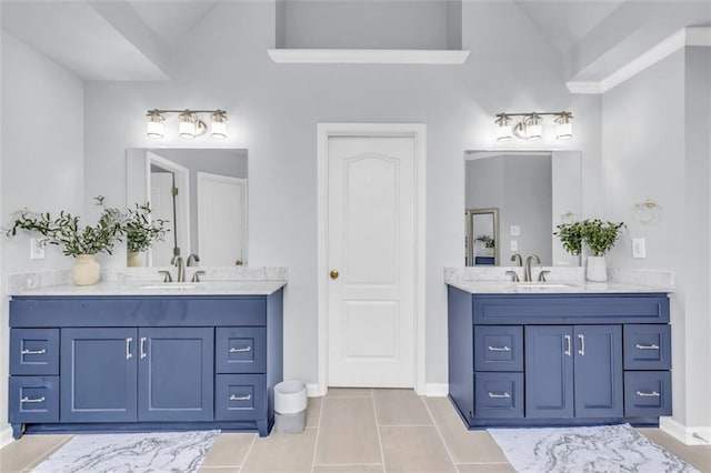 947 Summer Forest Dr, Suwanee, GA 30024 - full bathroom featuring two vanities, lofted ceiling, tile patterned flooring, and baseboards