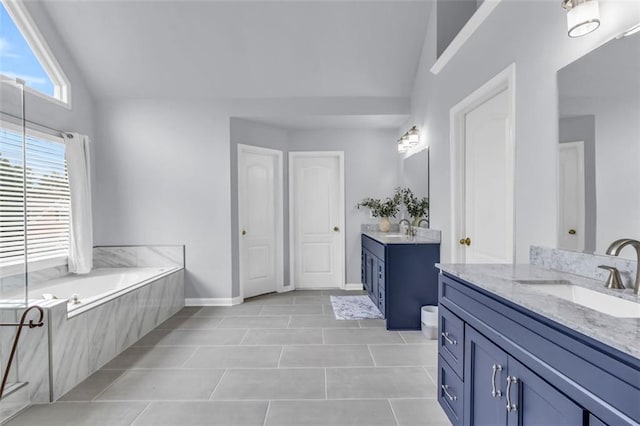 947 Summer Forest Dr, Suwanee, GA 30024 - bathroom with lofted ceiling, two vanities, tile patterned floors, a bath, and baseboards