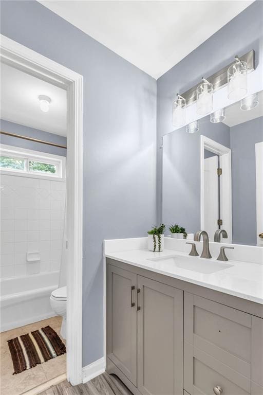 947 Summer Forest Dr, Suwanee, GA 30024 - bathroom with vanity, toilet, washtub / shower combination, wood finished floors, and baseboards