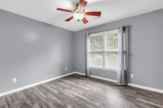 947 Summer Forest Dr, Suwanee, GA 30024 - spare room featuring wood finished floors, a ceiling fan, and baseboards