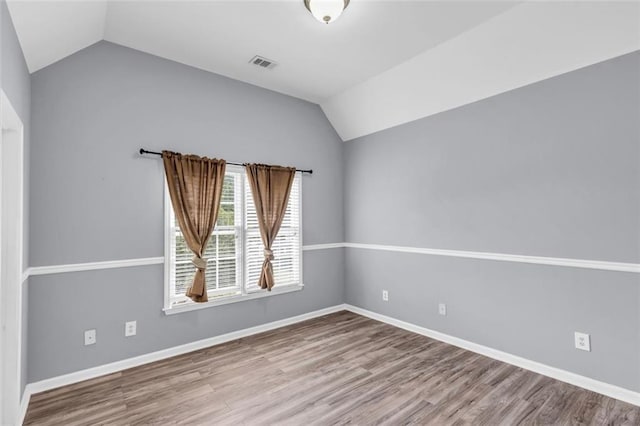 947 Summer Forest Dr, Suwanee, GA 30024 - unfurnished room featuring lofted ceiling, wood finished floors, and baseboards