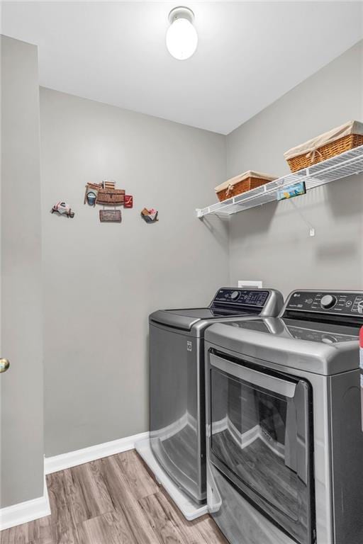 947 Summer Forest Dr, Suwanee, GA 30024 - washroom with washer and dryer, light wood-type flooring, and baseboards