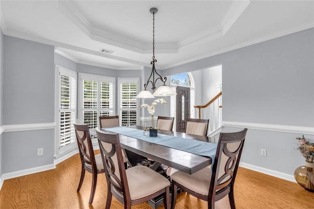 947 Summer Forest Dr, Suwanee, GA 30024 - dining room with a tray ceiling, light wood-style floors, ornamental molding, and baseboards