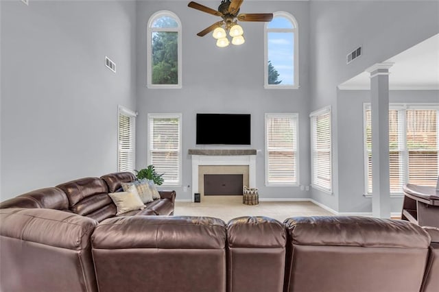 947 Summer Forest Dr, Suwanee, GA 30024 - living area featuring ceiling fan, a towering ceiling, baseboards, a fireplace, and carpet flooring