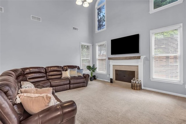 947 Summer Forest Dr, Suwanee, GA 30024 - carpeted living room featuring baseboards, healthy amount of natural light, a towering ceiling, and a fireplace