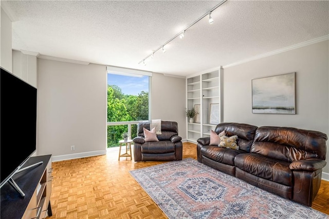 130 26th St NW Unit 415, Atlanta, GA 30309 - living area with a textured ceiling, rail lighting, built in shelves, and ornamental molding