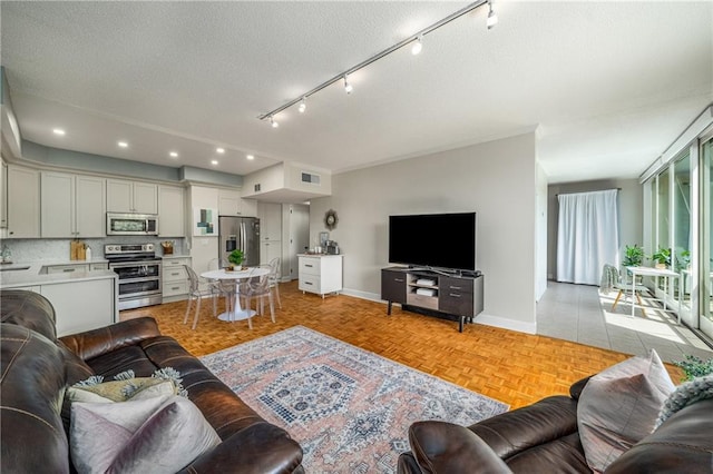 130 26th St NW Unit 415, Atlanta, GA 30309 - living room featuring recessed lighting, a textured ceiling, and rail lighting