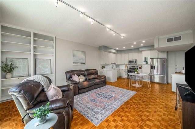130 26th St NW Unit 415, Atlanta, GA 30309 - living area featuring track lighting, a textured ceiling, and ornamental molding