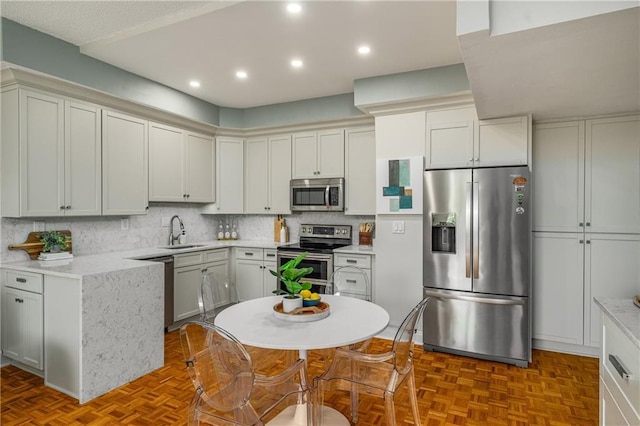130 26th St NW Unit 415, Atlanta, GA 30309 - kitchen featuring stainless steel appliances, recessed lighting, backsplash, and light stone countertops