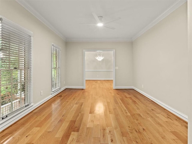 4515 N Slope Cir, Marietta, GA 30066 - empty room featuring a healthy amount of sunlight, light wood-type flooring, ornamental molding, and ceiling fan with notable chandelier