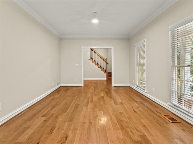 4515 N Slope Cir, Marietta, GA 30066 - empty room featuring light wood-style flooring, visible vents, baseboards, ornamental molding, and stairs