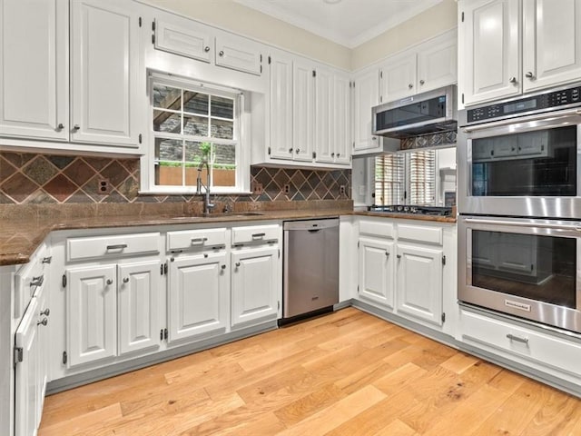4515 N Slope Cir, Marietta, GA 30066 - kitchen featuring dark countertops, a sink, white cabinetry, and stainless steel appliances
