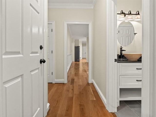 4515 N Slope Cir, Marietta, GA 30066 - hall featuring baseboards, ornamental molding, light wood-style floors, and a sink