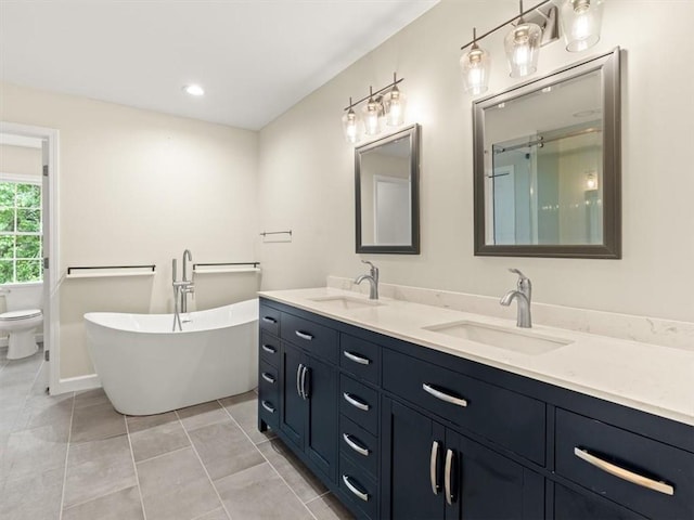 4515 N Slope Cir, Marietta, GA 30066 - bathroom with double vanity, toilet, a freestanding bath, and a sink