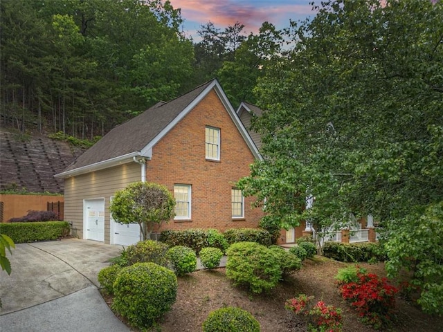 4515 N Slope Cir, Marietta, GA 30066 - property exterior at dusk with driveway, an attached garage, and brick siding